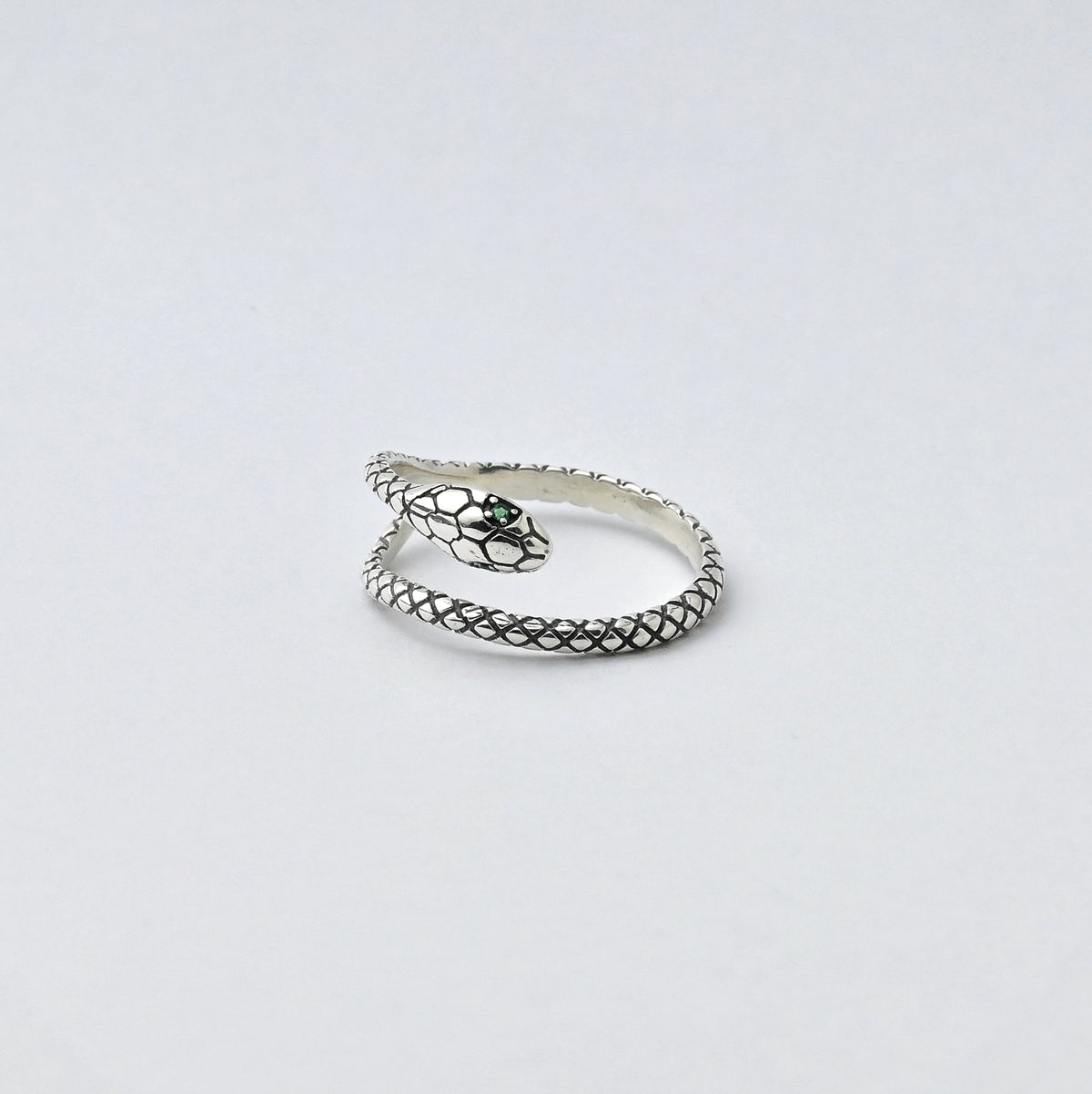 Green-Eyed Serpent sterling silver ring with sculpted scale texture and green eye details