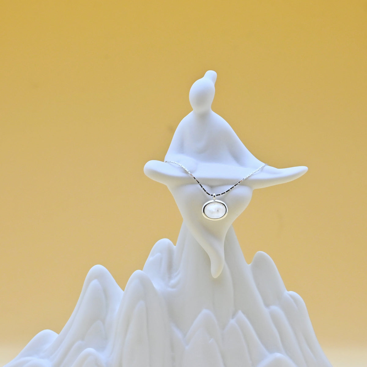 Sterling silver moonstone necklace with a luminous central stone, symbolizing reflection and renewal