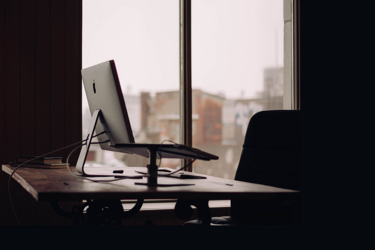 Home office desk placed beside a large window, illustrating feng shui desk-placement tradeoffs
