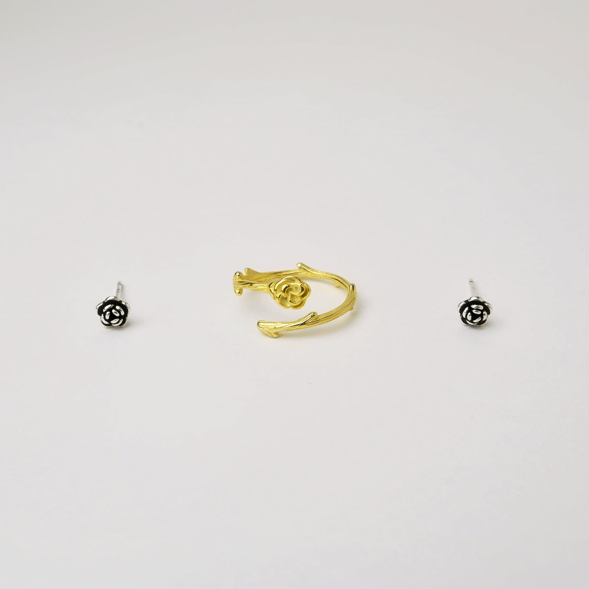 Gold-tone rose ring paired with silver rose earrings to demonstrate mixed-metal jewelry styling