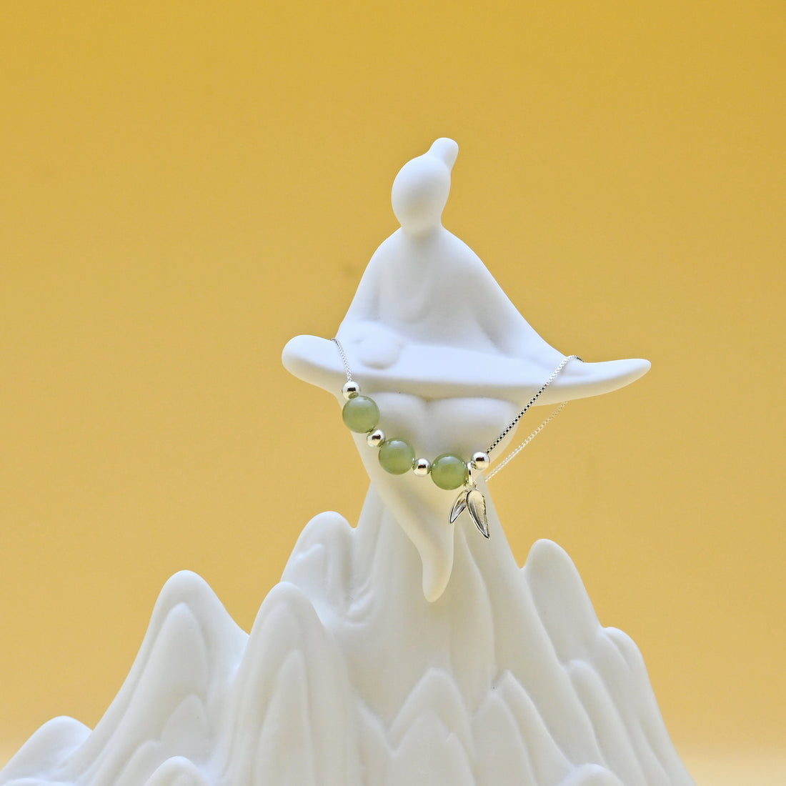 Hetian jade bamboo leaf necklace in sterling silver symbolizing resilience and steady growth