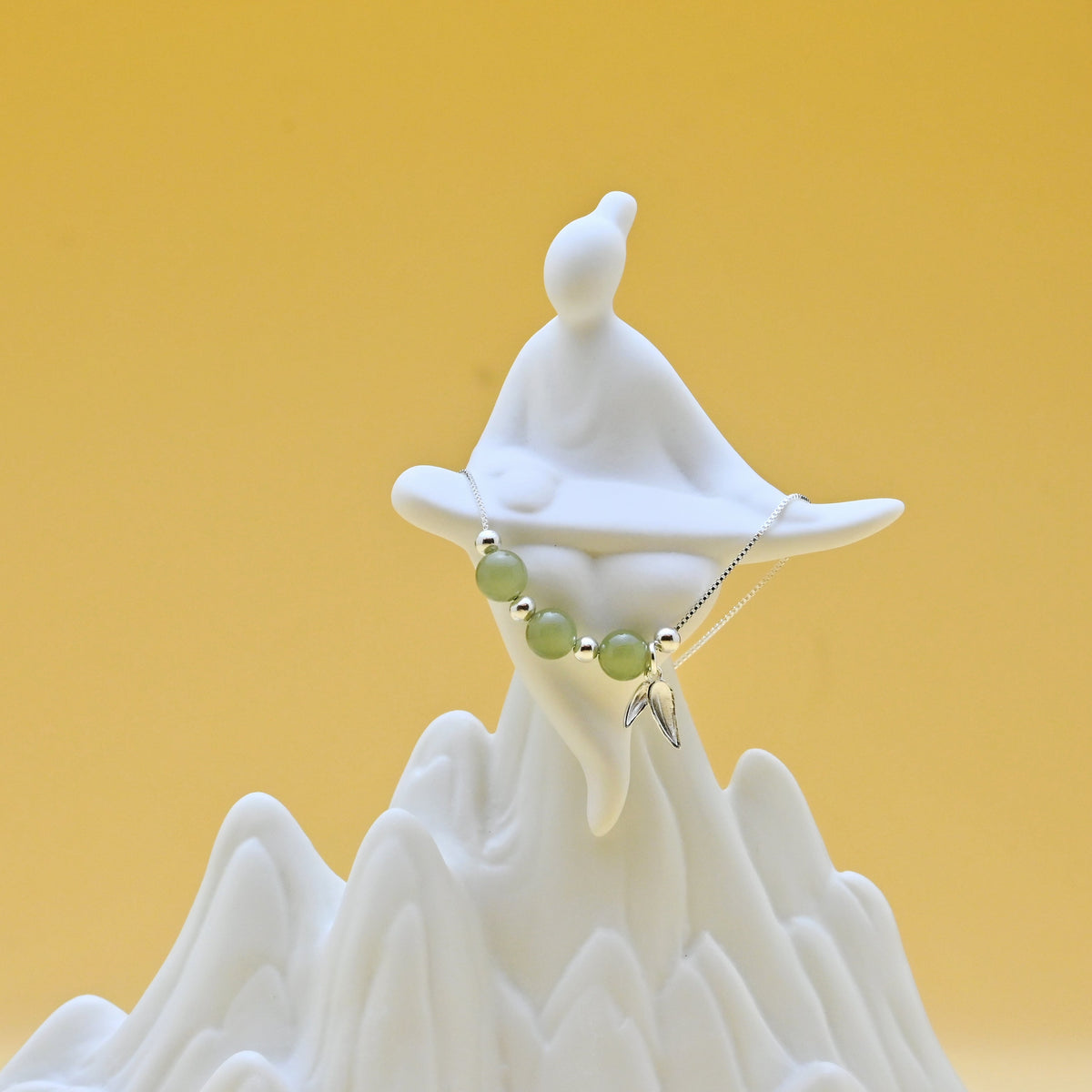 Hetian jade bamboo leaf necklace in sterling silver symbolizing resilience and steady growth